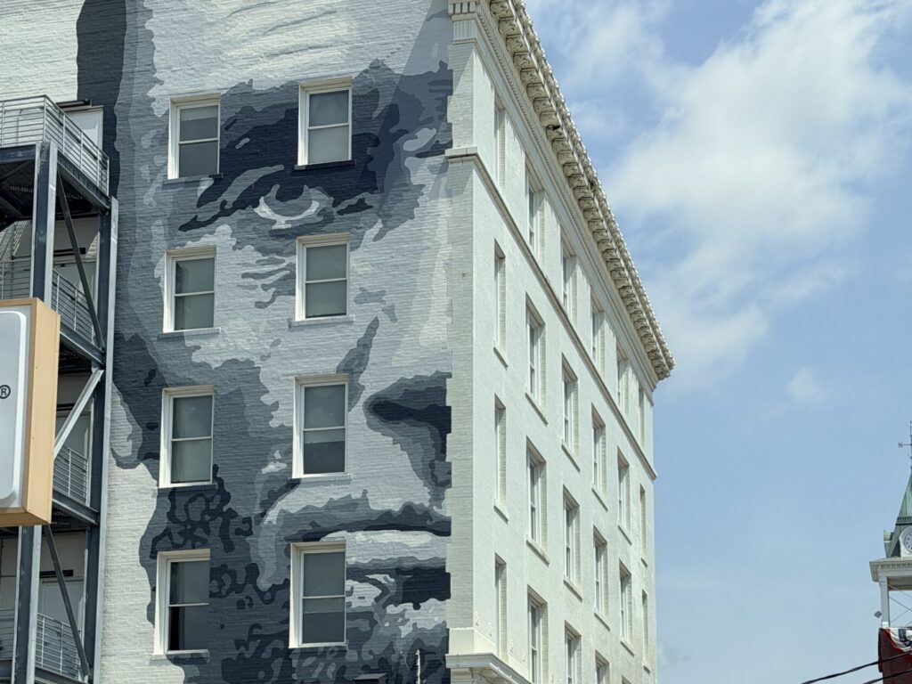 Abraham Lincoln's face painted on the side of a building against a blue sky
