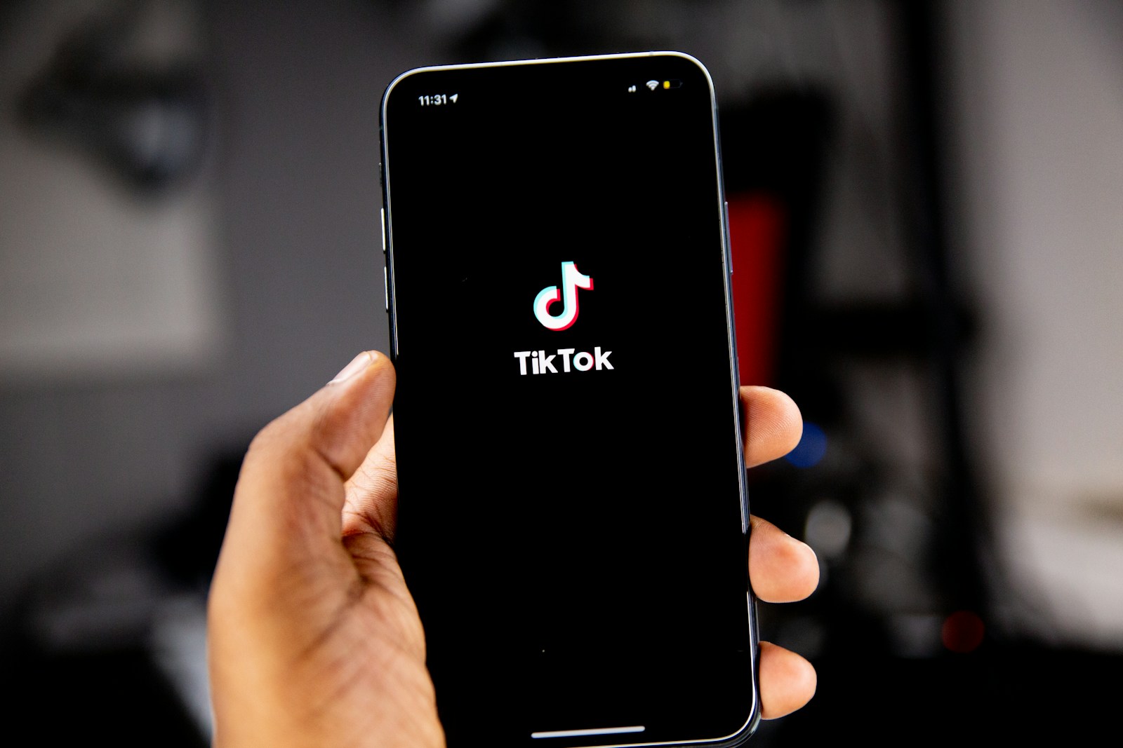 Person holding an iPhone running TikTok
