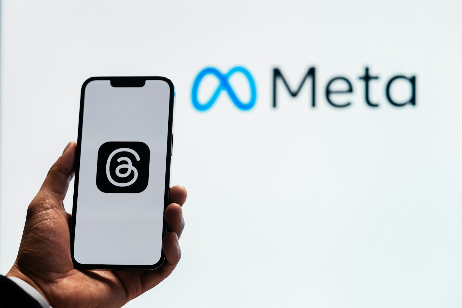 Young man using new meta threads app on smartphone