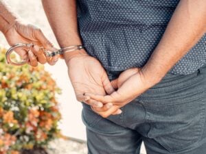 No Ticket, No Arrest, Still a Case: What a Wrongful Police Stop Is Worth 8 Police officer placing handcuffs on a man with his hands behind his back.