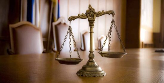 https-johntfloyd-com-wp-content-uploads-2026-07-scales-of-justice-tilted-1042x530-1-jpg
