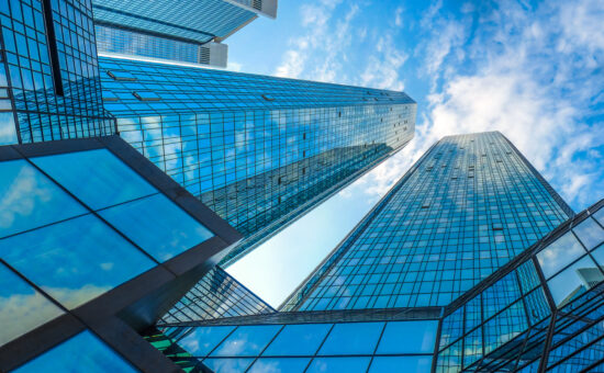 Modern skyscrapers in business district against blue sky