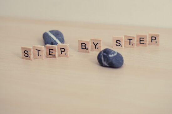 Step by step, wooden letter photography. Wood and stones. Progress