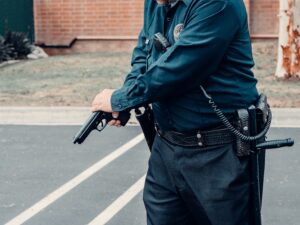 The Bane Act: California's Civil Rights Law and the Fight Over Intent 8 Police officer handling a handgun while standing in a parking lot.