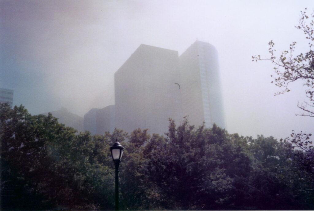 Lower Manhattan skyscrapers obscured by heavy smoke and dust
